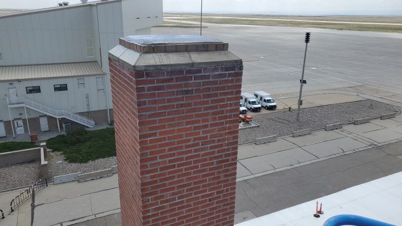 Finished brick chimney with its new crown beside Hangar 208 at Mountain Home Air Force Base