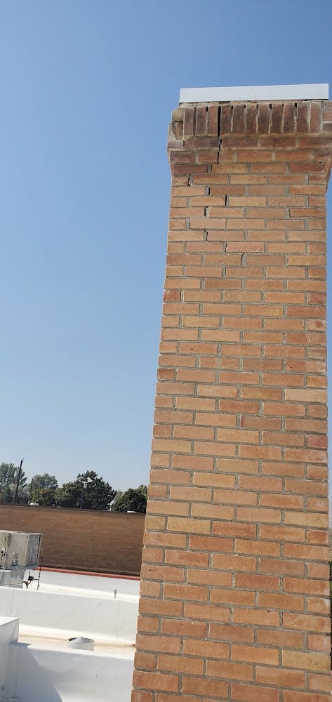 Cracked mortar and loose bricks below the crown of the Owyhee County Courthouse chimney, Murphy, Idaho